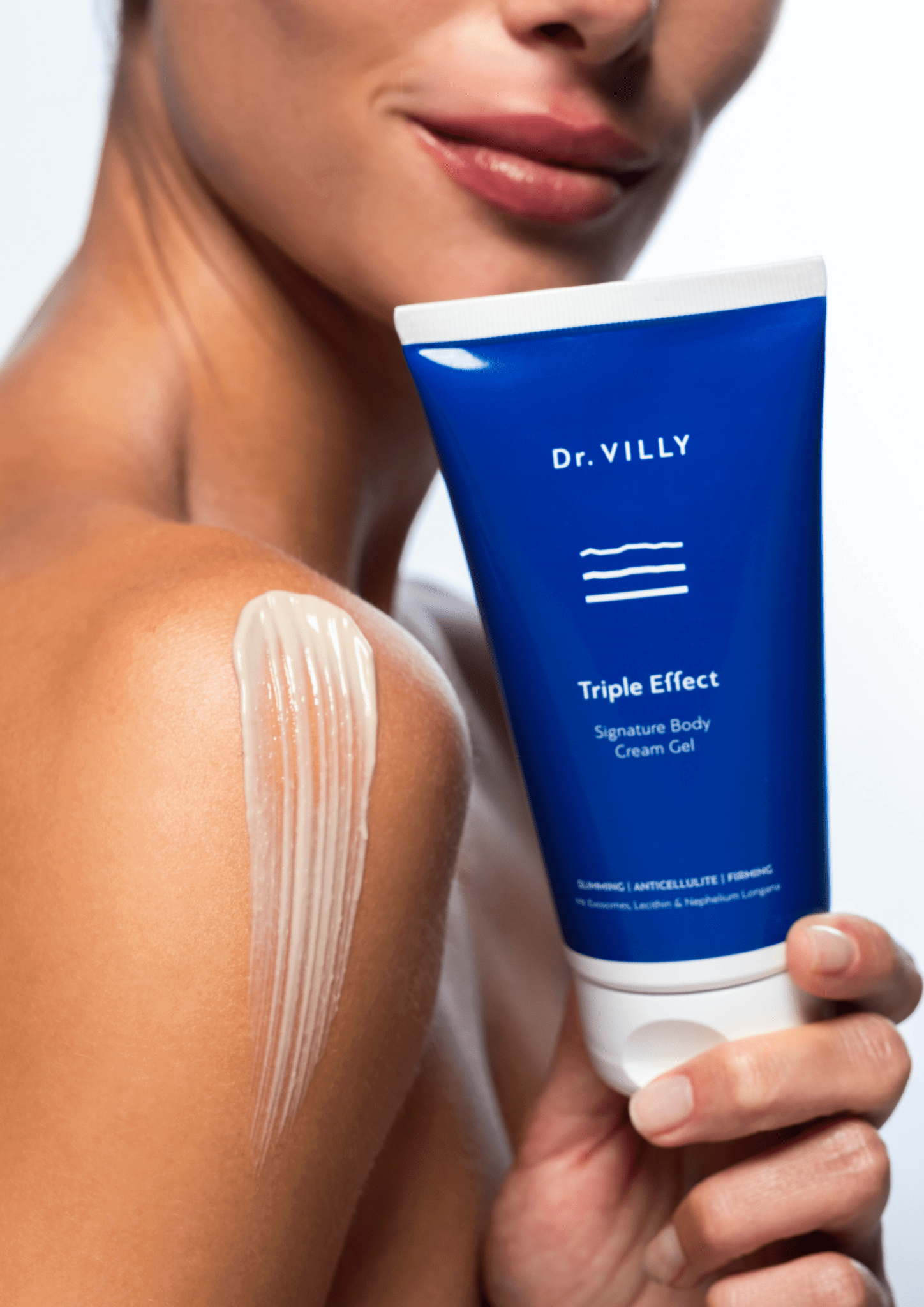 Image of model holding an 150 ml of Triple Effect Body Cream Gel with Patented Citrus Exosomes by Dr. Villy Skincare, a medical Grade cream gel with anti‑cellulite, firming and toning properties for all skin types.